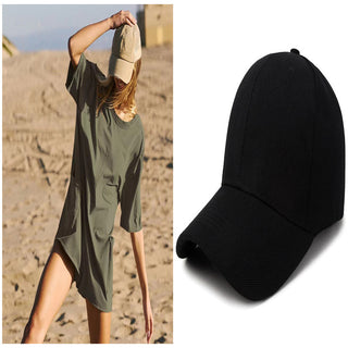 Casual women's jumpsuit with backless design on desert landscape with black baseball cap