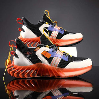 Futuristic sneakers with bold black and white color scheme, featuring bright orange soles and distinctive geometric accents for a striking, modern look.