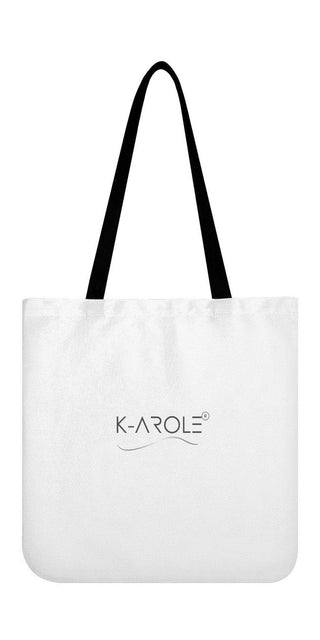 Women's trendy white canvas tote bag with black straps and K-AROLE logo displayed prominently, showcasing the brand's stylish and versatile fashion accessories.