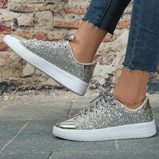 Sparkling silver glitter sneakers with a sleek, lace-up design and thick platform soles for casual, trendy footwear.