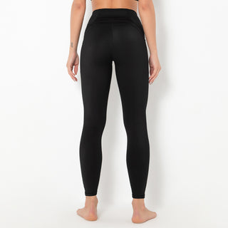Sleek and stylish black yoga pants showcased on a woman's lower body. The pants appear to be made of a stretchy, moisture-wicking fabric suitable for athletic activities.