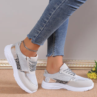 Stylish women's sneakers with breathable mesh fabric, lace-up closure, and chunky soles for a modern, sporty look. The sneakers feature a sleek, lightweight design perfect for casual wear or athletic activities.