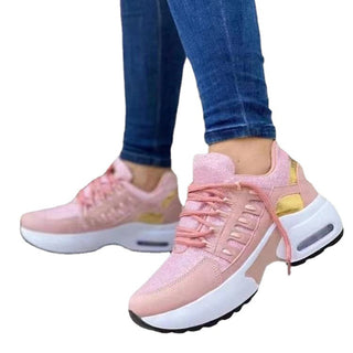 Stylish pink and white women's sneakers with chunky sole, designed for casual athleisure wear.