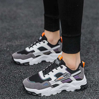 Stylish gray and black lace-up sneakers with breathable mesh panels and bright orange accents, suitable for outdoor activities and casual wear.
