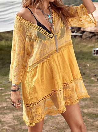 Vibrant yellow lace dress with bohemian accents, worn by a stylish woman in an outdoor setting