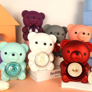 Assortment of colorful teddy bear figurines in a gift box packaging. The bears come in various sizes and shades, including red, white, mint green, and purple. The scene showcases the diverse and playful nature of these decorative bears, creating a visually appealing display.