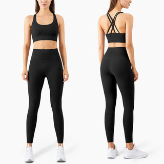 Stylish black sports bra and leggings outfit for an active woman. The athletic apparel features a supportive racerback design and high-waisted, form-fitting silhouette to provide comfort and mobility during fitness activities. The neutral color scheme and minimal branding make this a versatile athleisure ensemble.