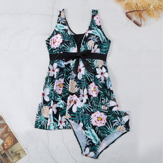 Colorful floral printed women's v-neck split bikini swimsuit with pineapple design on light background.