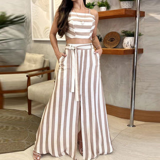 Elegant striped two-piece women's outfit. Sleeveless crop top with horizontal stripes paired with high-waisted, wide-leg striped pants. Fashionable and trendy casual summer ensemble.