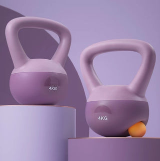 Pink fitness kettlebells on purple platforms