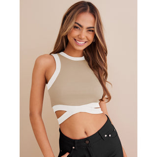 Fashionable cropped top with contrast color details showcased on a smiling young woman with long brown hair.
