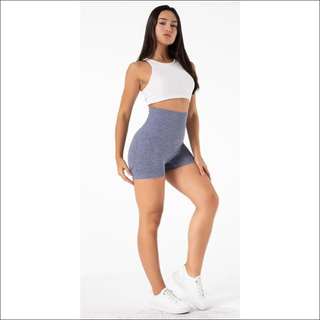 Chic yoga attire: white racerback top, gray shorts, and stylish white sneakers. A trendy, comfortable outfit perfect for yoga or activewear. The image showcases the versatile and fashionable nature of the product.