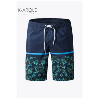 Vibrant printed color block lace-up women's athletic shorts from K-AROLE. Bold floral pattern in shades of green and navy, with drawstring waist for a customized fit. Versatile athleisure piece for an active lifestyle.