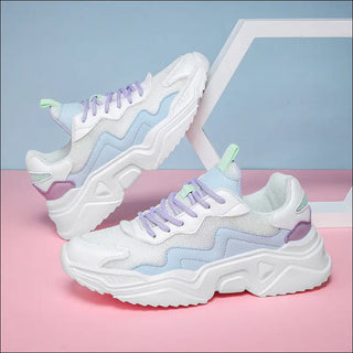 Stylish white and purple sneakers with chunky soles and eye-catching design details, displayed on a pink and blue background.