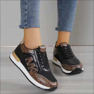 Stylish women's sneakers with leopard print and lace-up design, featuring a thick, comfortable sole for trendy, sporty look.