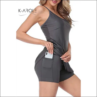 Stylish woman's pocketed tennis yoga running dress by K-AROLE, featuring a sleeveless design and a flattering fit for active lifestyles.