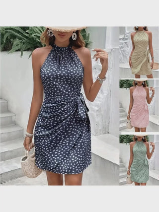 Stylish summer dress with halter neckline and tied waistline, showcasing a modern floral print design. Versatile and fashionable piece for women's casual or formal attire.