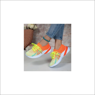 Vibrant mesh sneakers with colorful accents. Lace-up sports shoes with breathable design for comfortable walking or running. Trendy women's casual footwear in eye-catching hues.