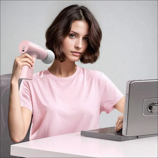 Pink Handheld Massage Device on White Table