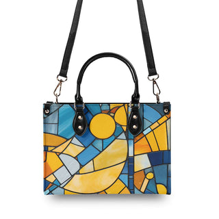 Vibrant mosaic-patterned tote bag with bold colors and geometric shapes, featuring a black leather-like trim and adjustable straps for versatile carrying.