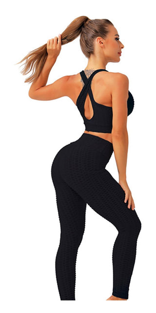 Inspiring fitness: Sleek black activewear with functional criss-cross back detail, highlighting a toned, confident figure.